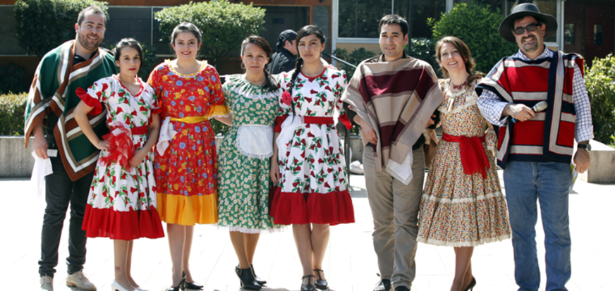 A group of people in traditional attire standing together outside.